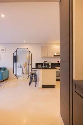 a kitchen with a large mirror in the middle of a room at Sublime appartement 2 chambres en plein centre entre Gueliz et hivernage avec piscine in Marrakech