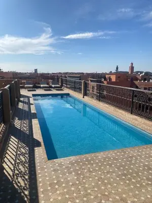 a large swimming pool on top of a building at Sublime appartement 2 chambres en plein centre entre Gueliz et hivernage avec piscine in Marrakech