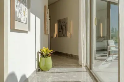 a hallway with a green vase on the floor at THE ESTATE - Marrakech in Marrakech