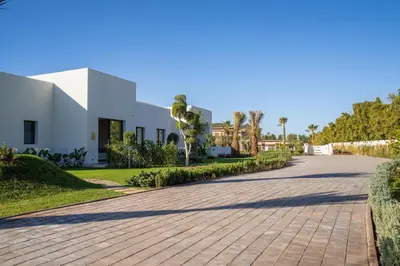 a driveway leading to a white house at THE ESTATE - Marrakech in Marrakech