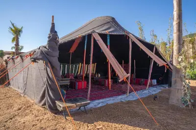 a tent with a bench in front of it at THE ESTATE - Marrakech in Marrakech
