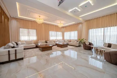 a large living room with white furniture and windows at Villa Soliya 4 Rooms with private pool in Marrakech