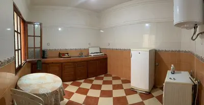 a kitchen with a checkered floor and a refrigerator at Appartement meublé calme près de l'aéroport menara in Marrakech