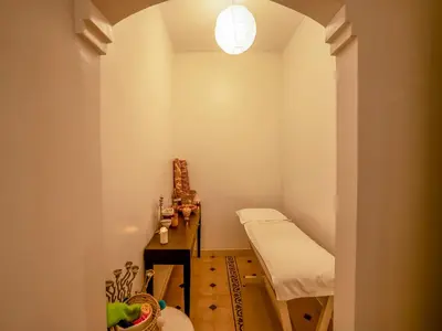 a small room with a bed and a table at Hôtel Boutique RAM SPA in Marrakech