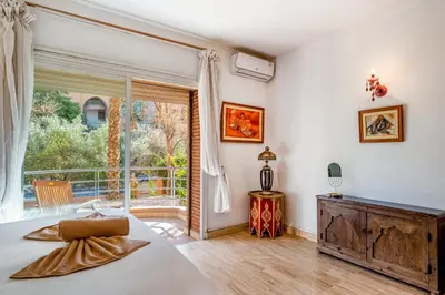 a bedroom with a bed and a large window at Bright & Cozy Appt with Exclusive Private terrace in Marrakech