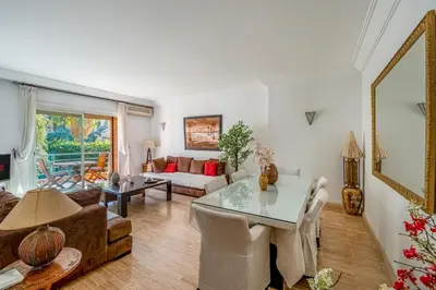 a living room with a table and a couch at Bright & Cozy Appt with Exclusive Private terrace in Marrakech