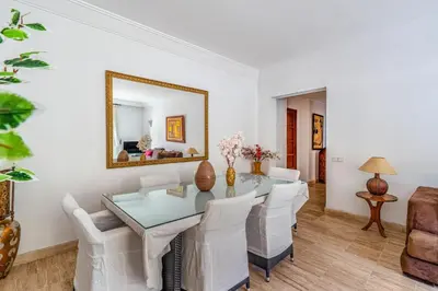 a dining room with a table and chairs and a mirror at Bright & Cozy Appt with Exclusive Private terrace in Marrakech