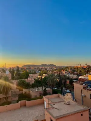 a view of a city from the roof of a building at Appartement avec piscine Vue colline à Gueliz in Marrakech