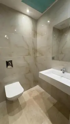 a bathroom with a white toilet and a sink at Stylish 1-Bed Retreat in Marrakech