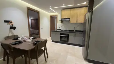 a kitchen and dining room with a table and a refrigerator at Stylish 1-Bed Retreat in Marrakech