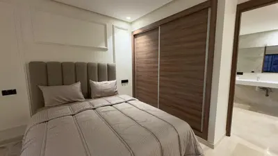 a bedroom with a bed with a large wooden door at Stylish 1-Bed Retreat in Marrakech