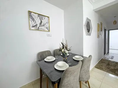 a dining room with a black table and chairs at L'Havre de Paix 2 in Marrakech