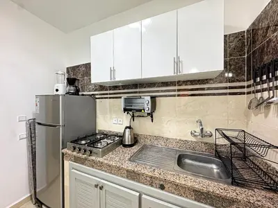 a kitchen with a sink and a refrigerator at L'Havre de Paix 2 in Marrakech