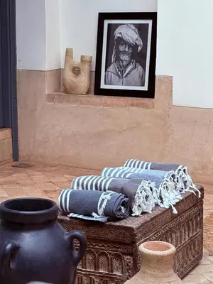 a room with vases and a picture of a man at Riad melqa piscine privée - Medina Marrakech in Marrakech
