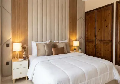 a bedroom with a large white bed and two lamps at Appart de luxe 3 in Marrakech