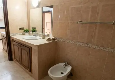 a bathroom with a sink and a toilet and a mirror at Appart de luxe 3 in Marrakech