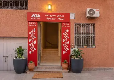 an entrance to a building with potted plants in front at Appart de luxe 3 in Marrakech