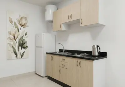 a kitchen with wooden cabinets and a white refrigerator at Appart de luxe 3 in Marrakech