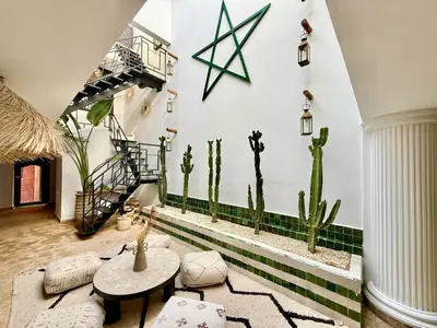 a living room with cacti on the wall at Maison Meurisse Sta'a private pool breakfast in Marrakech