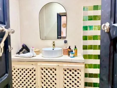 a bathroom with a sink and a mirror at Maison Meurisse Sta'a private pool breakfast in Marrakech
