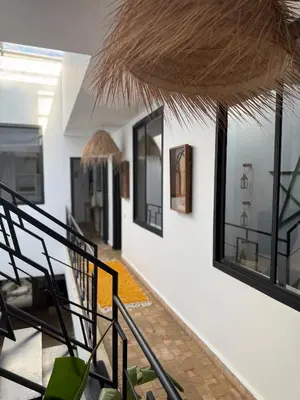 a room with a staircase with a bunch of windows at Maison Meurisse Sta'a private pool breakfast in Marrakech