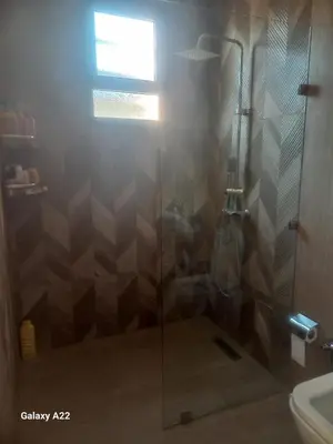 a shower with a glass door in a bathroom at Villa Marrackech in Marrakech