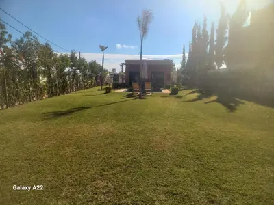 a large grass field with a building in the distance at Villa Marrackech in Marrakech