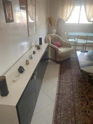 a living room with a couch and a chair at Appartement hivernage in Marrakech