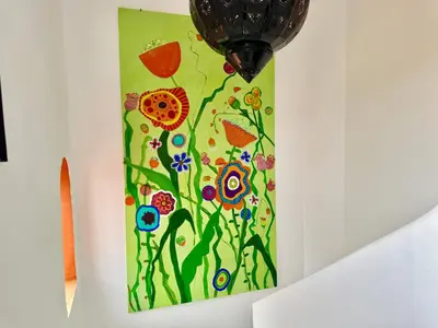 a painting of flowers on a wall at Riad Florival breakfast private kasbah in Marrakech