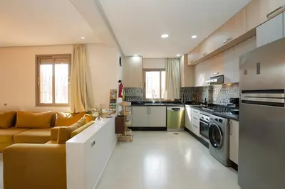 a living room with a couch and a kitchen at Maison M, Spacious 2-Bedroom Apartment in Marrakech in Marrakech