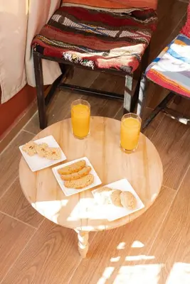 a table with two glasses of orange juice and cookies on it at Maison M, Spacious 2-Bedroom Apartment in Marrakech in Marrakech