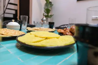 a table topped with plates of food on a table at Maison Meurisse KHAMSaPrivate pool and breakfast in Marrakech