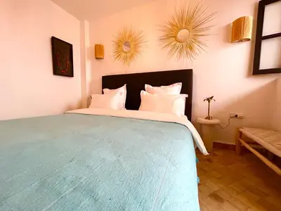 a bedroom with a large bed with white pillows at Maison Meurisse KHAMSaPrivate pool and breakfast in Marrakech