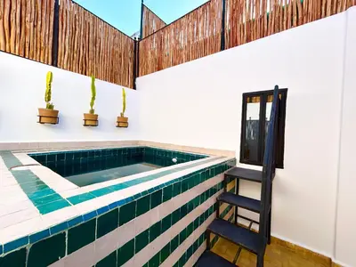 a swimming pool in a house with a ladder at Maison Meurisse KHAMSaPrivate pool and breakfast in Marrakech