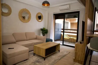 a living room with a couch and a coffee table at Le Loft Chic Hivernage Piscine & Parking Privé in Marrakech