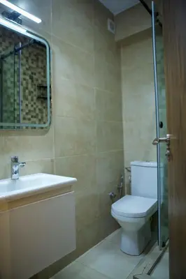 a bathroom with a toilet and a sink and a mirror at Le Loft Chic Hivernage Piscine & Parking Privé in Marrakech
