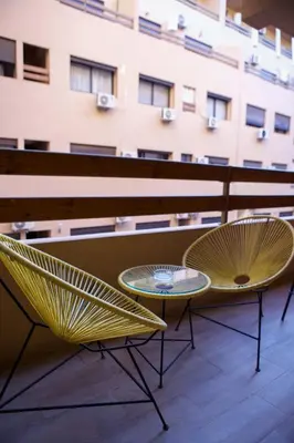 two chairs and a table on a balcony at Le Loft Chic Hivernage Piscine & Parking Privé in Marrakech
