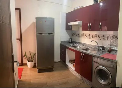 a kitchen with a refrigerator and a washing machine at Appt á louer TF2 in Marrakech