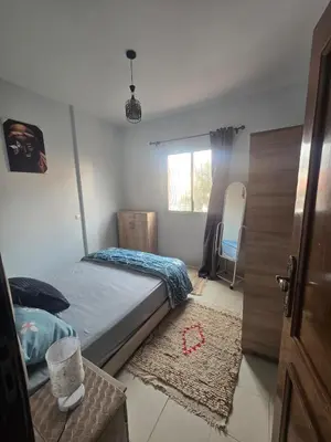 a small bedroom with a bed and a window at Beautiful comfortable apartment in a secure residence in Marrakech