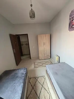 an empty bedroom with two beds and a closet at Beautiful comfortable apartment in a secure residence in Marrakech