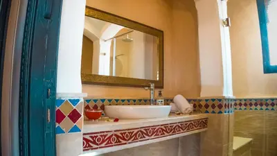a bathroom with a sink and a mirror at Villa Aylal in Marrakech