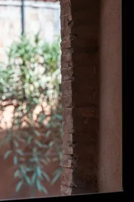a brick wall with a plant in the background at Villa Aylal in Marrakech
