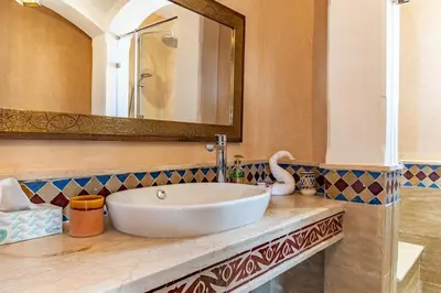 a bathroom with a white sink and a mirror at Villa Aylal in Marrakech