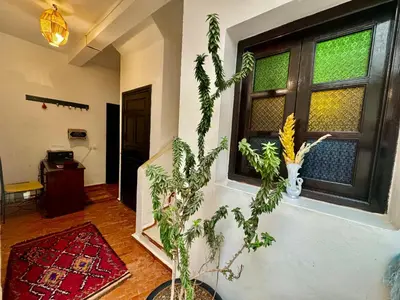 a living room with a window and a plant at Riad Iklil hcekarram in Marrakech