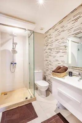 a bathroom with a glass shower and a toilet at Résidence jnan ali 4 Marrakech in Marrakech