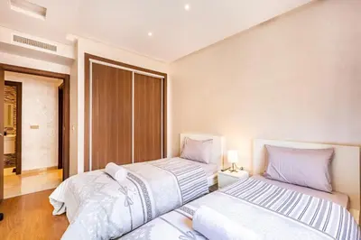 two beds sitting next to each other in a bedroom at Résidence jnan ali 4 Marrakech in Marrakech
