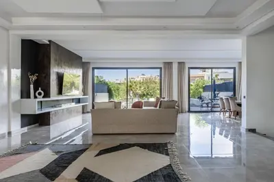 a living room with a couch and a table at Villa Sunstone Marrakech in Marrakech
