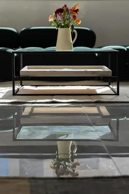 a living room with a couch and a table with flowers at Villa Sunstone Marrakech in Marrakech