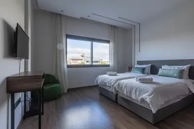 a bedroom with a large bed and a window at Villa Sunstone Marrakech in Marrakech