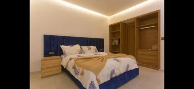 a bedroom with a bed with a blue headboard at Modern 3-Bed retreat in Gueliz near Train station in Marrakech